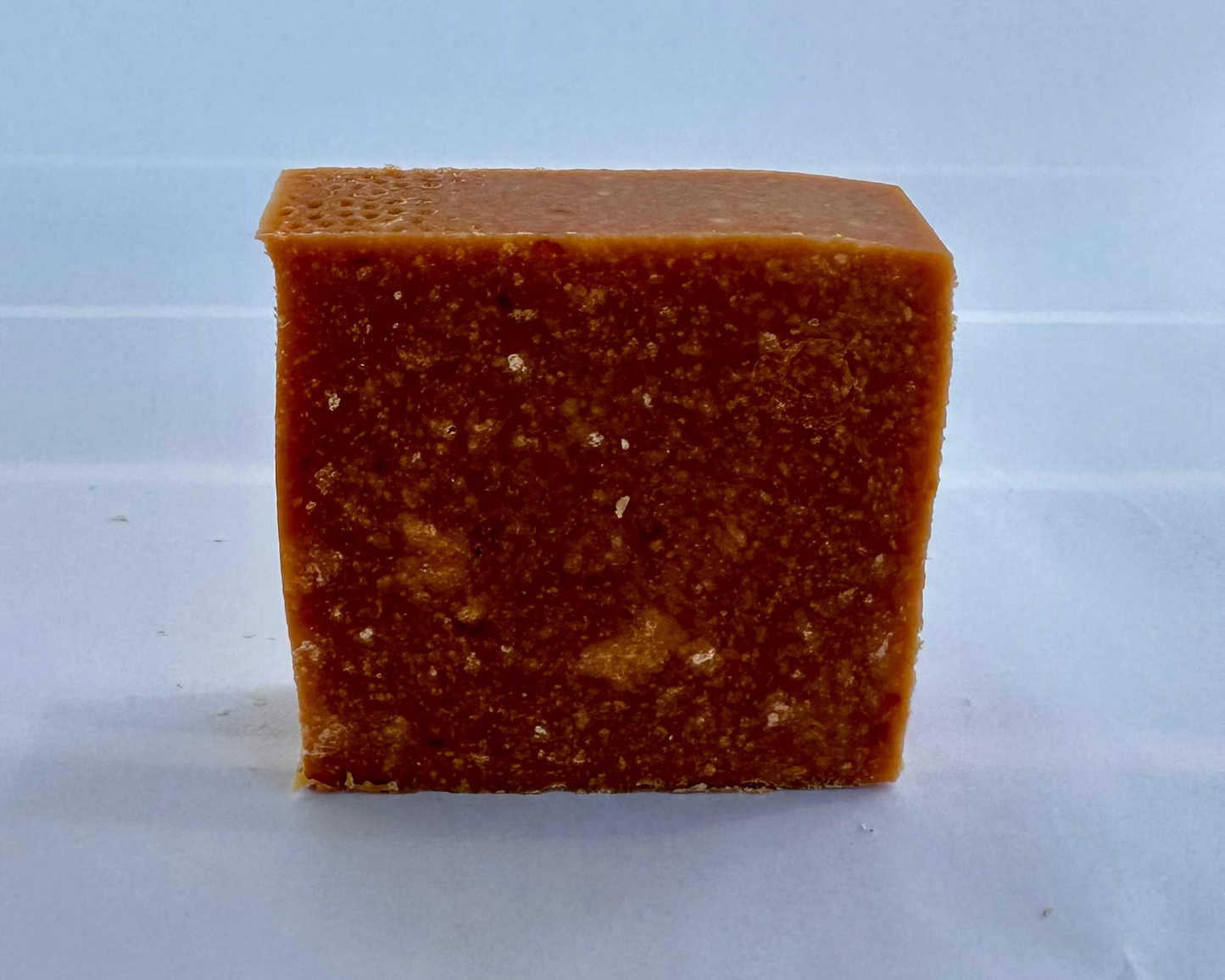 Red bar of soap on a white background