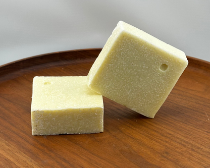 Two bars of Himalayan salt soap on a wooden board with a white background