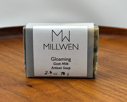 Bar of soap with a label on a wooden surface